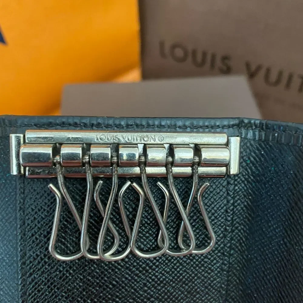 Auth LV black epi key fob is A+‎ condition. Matching wallet and bag available